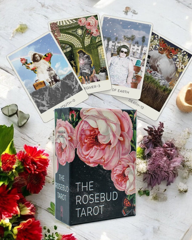 Rosebud Tarot box with tarot cards and flowers on a white surface